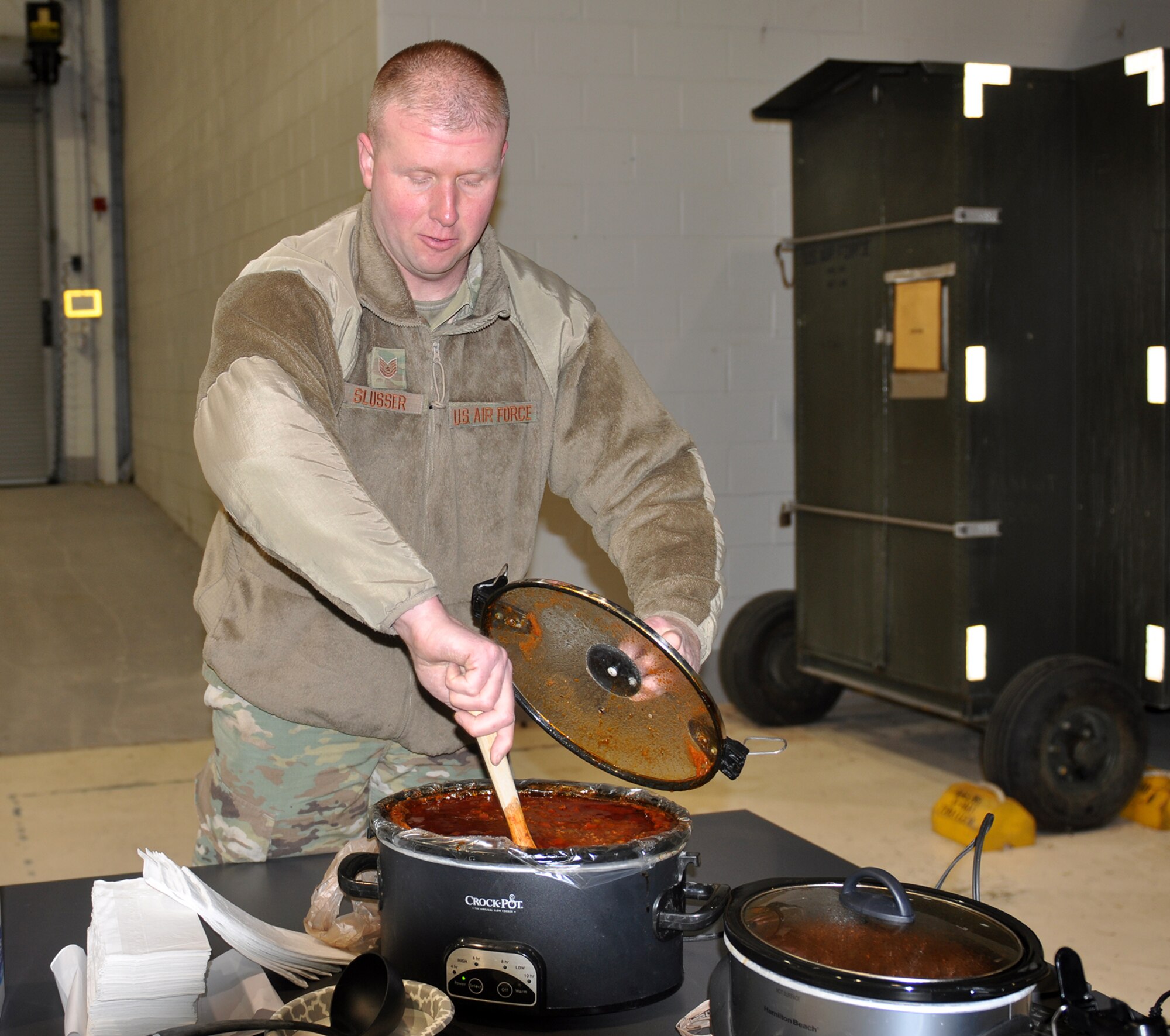 Tech. Sgt. Joshua Slusser’s, 445th Maintenance Squadron aerospace ground equipment craftsman, stirs his chili before judging during the 445th Airlift Wing’s chili cook-off Dec. 2, 2019, to support the Toys for Tots campaign. Attendees were asked to donate a toy for a bowl of chili and dessert. Slusser won first place for his chili.