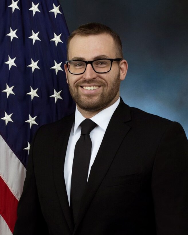 official photo with blue background and American flag