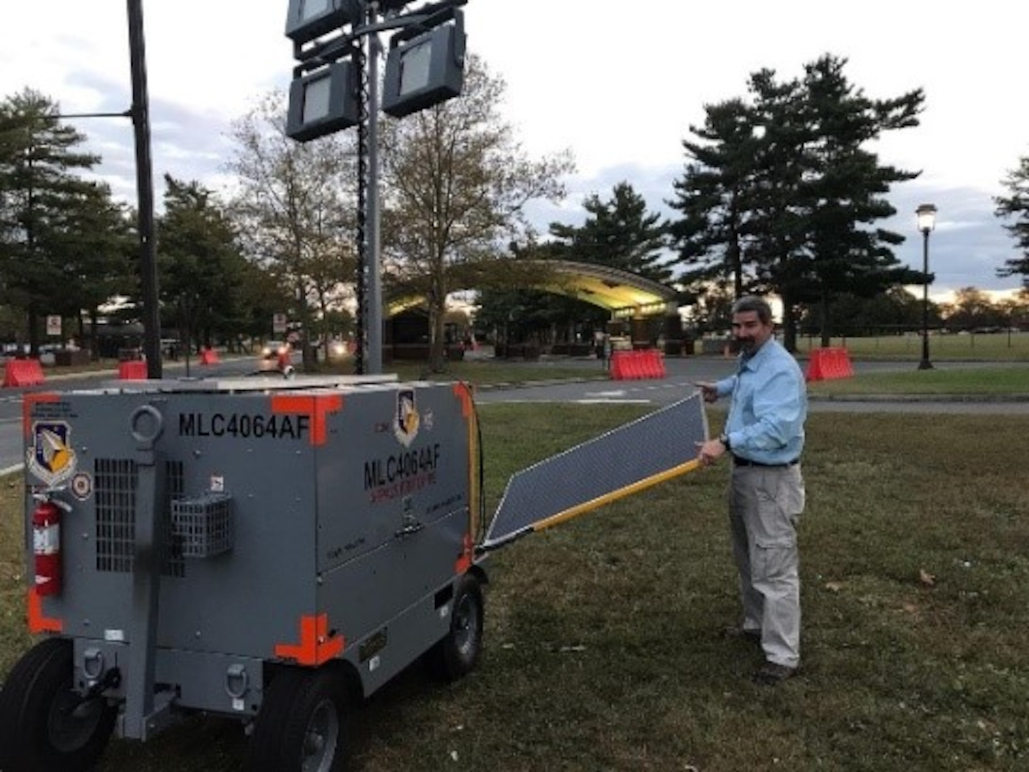 Jeff Hill, lead engineer from the Air Force Life Cycle Management Center’s Support Equipment Program Office collects data from the hybrid cart and displays solar panels on the Advanced Flightline Power and Light System at gates at Joint Base McGuire-Dix-Lakehurst, New Jersey. (U.S. Air Force photo/Master Sgt. John Bono)