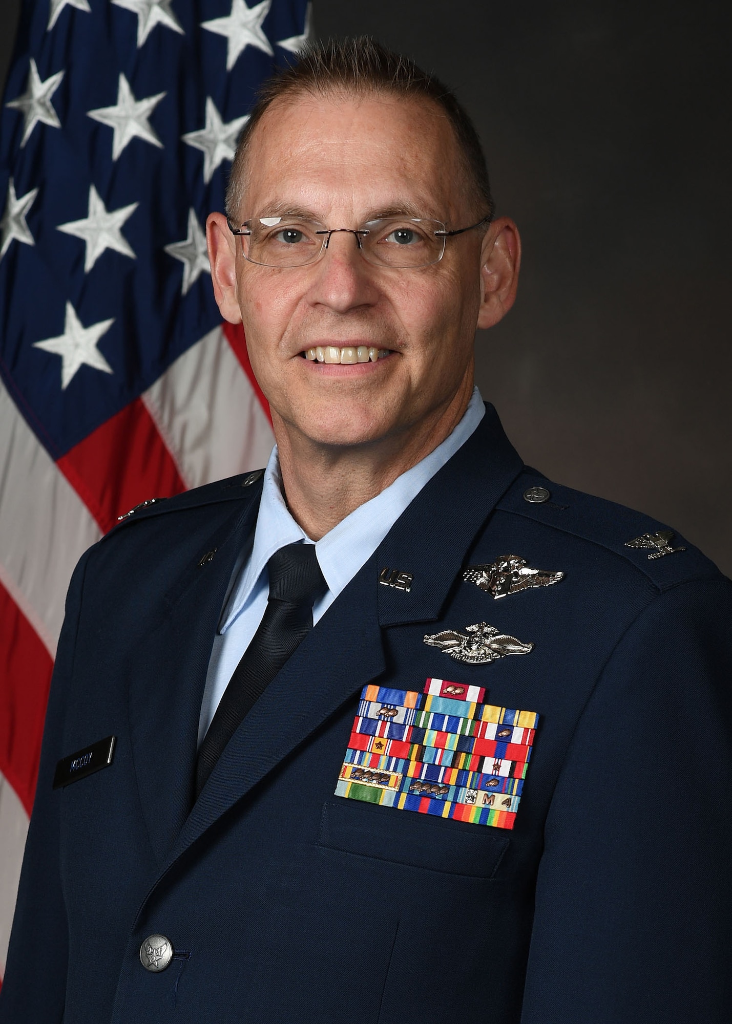 Col Robert McCoy official photo with American flag background