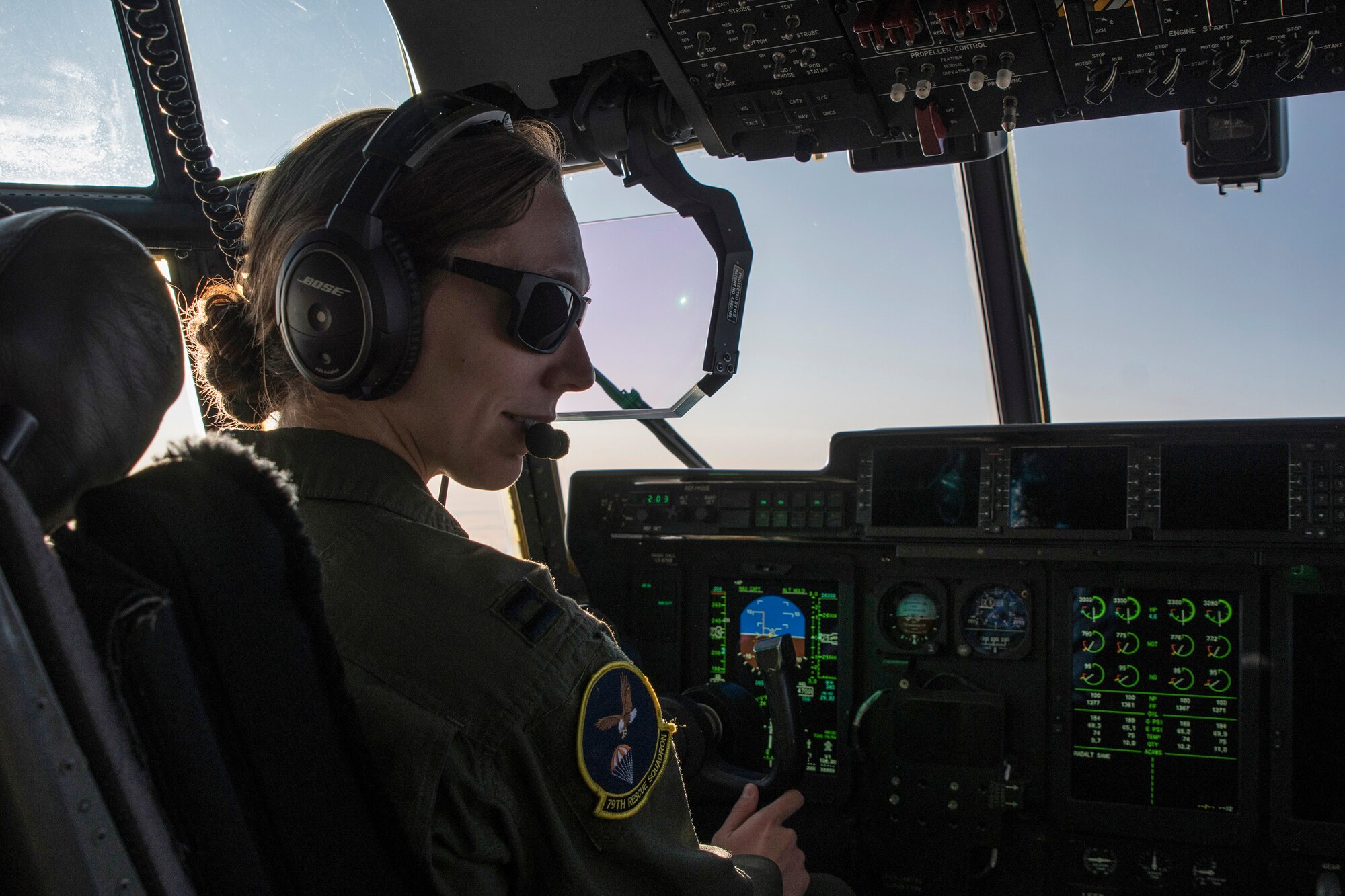Photo of a pilot inside the cockpit of a military aircraft during a flight.