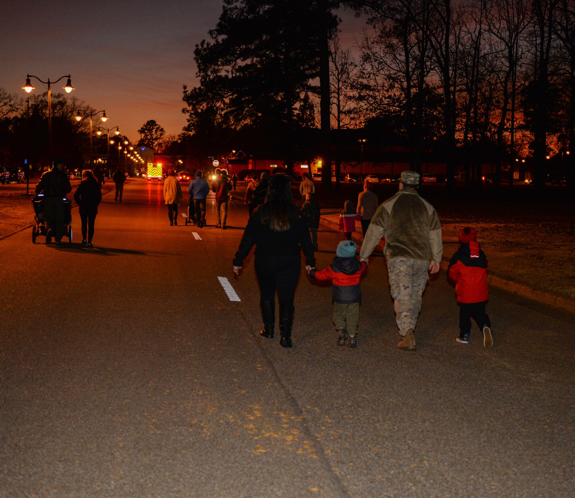 Families walk in a holiday parade Dec. 3, 2019, at Columbus Air Force Base, Miss. Team BLAZE kicked off the holiday season with Santa’s T-1A Jayhawk arrival followed by a tree lighting ceremony. (U.S. Air Force photo by Airman Davis Donaldson)