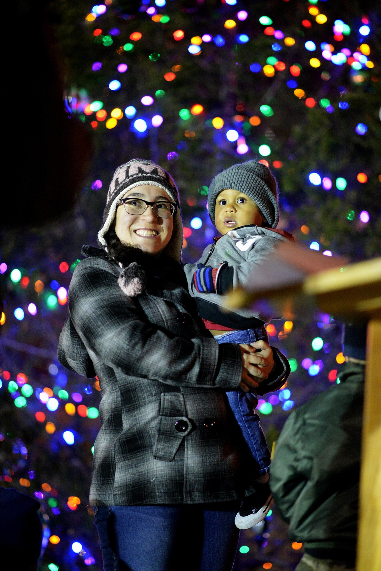 Jo Jackson and her son, Desmond, smile after helping light the 2019 Team BLAZE Christmas tree in honor of deployed Columbus Air Force Base Airmen on Dec. 3, 2019, at Columbus Air Force Base, Miss. Jackson’s husband has been, and will be deployed during the holiday season. (U.S. Air Force photo by Senior Airman Keith Holcomb)