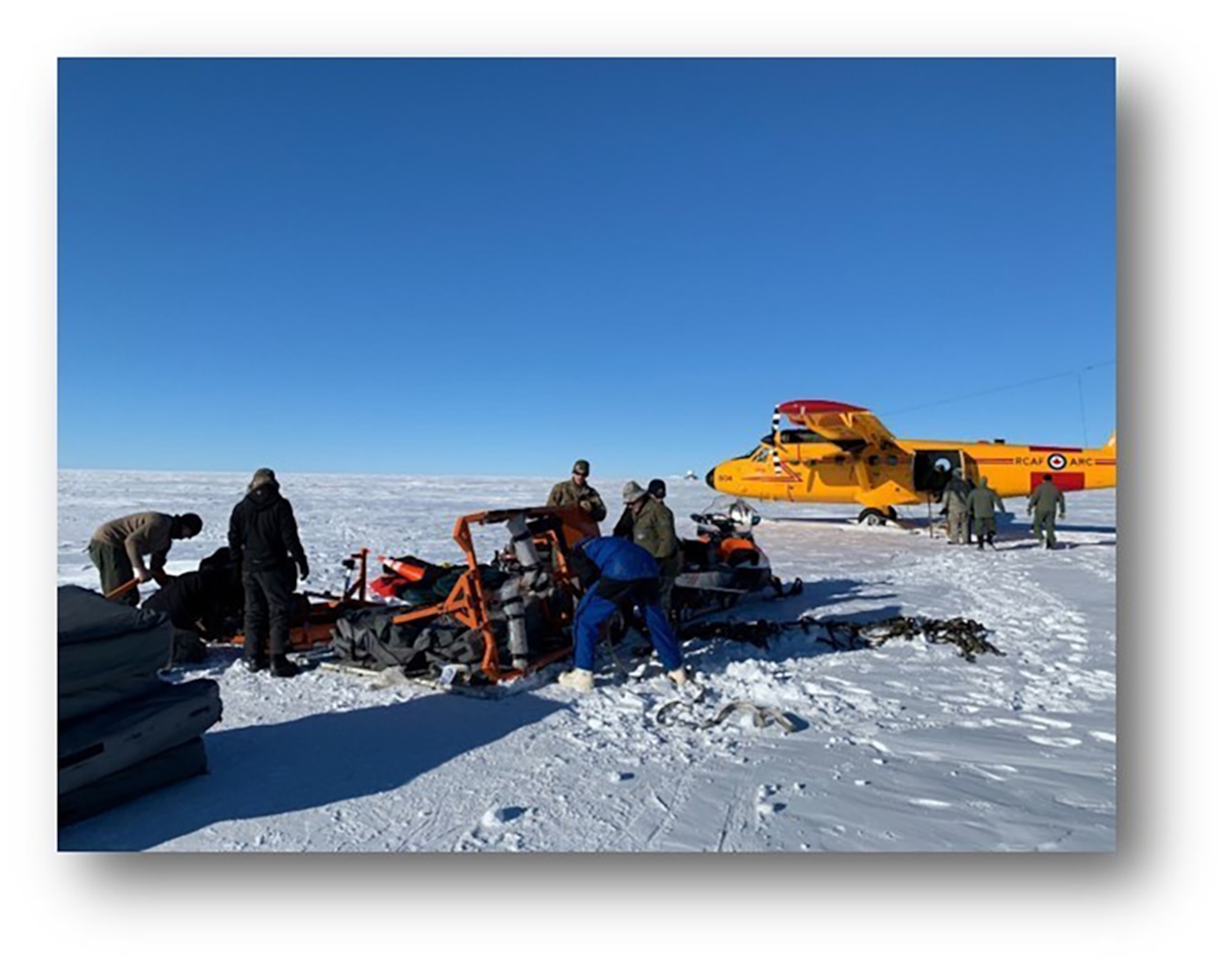 Airmen from the 109th Airlift Wing work to build a skiway in the Arctic. The Canadian Air Force drop Airmen and supplies in and the Airmen build a skiway for ski-equipped heavy airlift to land on.