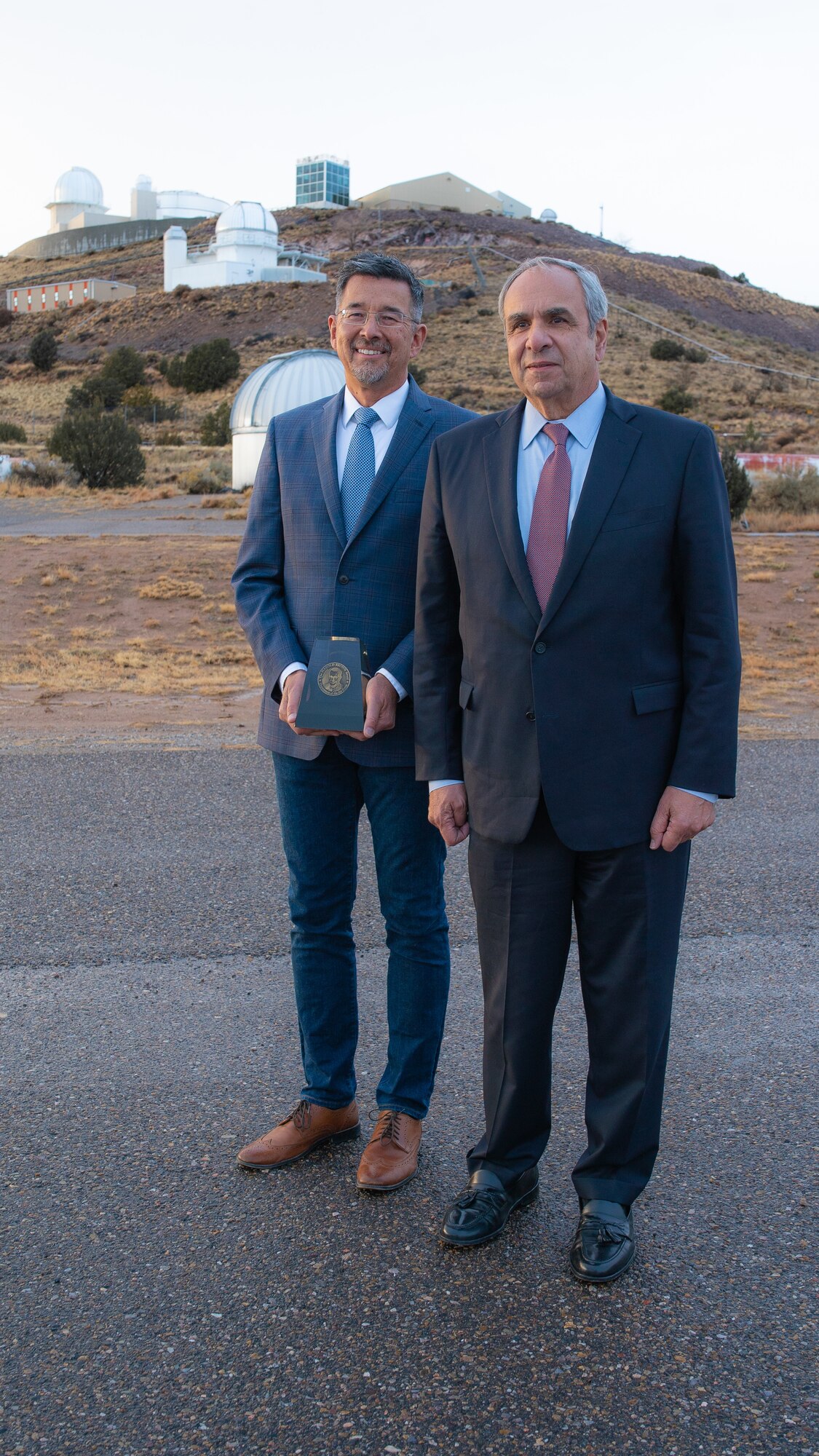 Left to Right: Air Force Research Laboratory 2018 Harold Brown Award winner Dr. Robert Johnson and Dr. Richard Joseph Chief Scientist of the Air Force stand in front of AFRL's Starfire Optical Range telescopes following the award presentation ceremony on Nov. 21, 2019. (U.S. Air Force photo/ Macee Hunt)