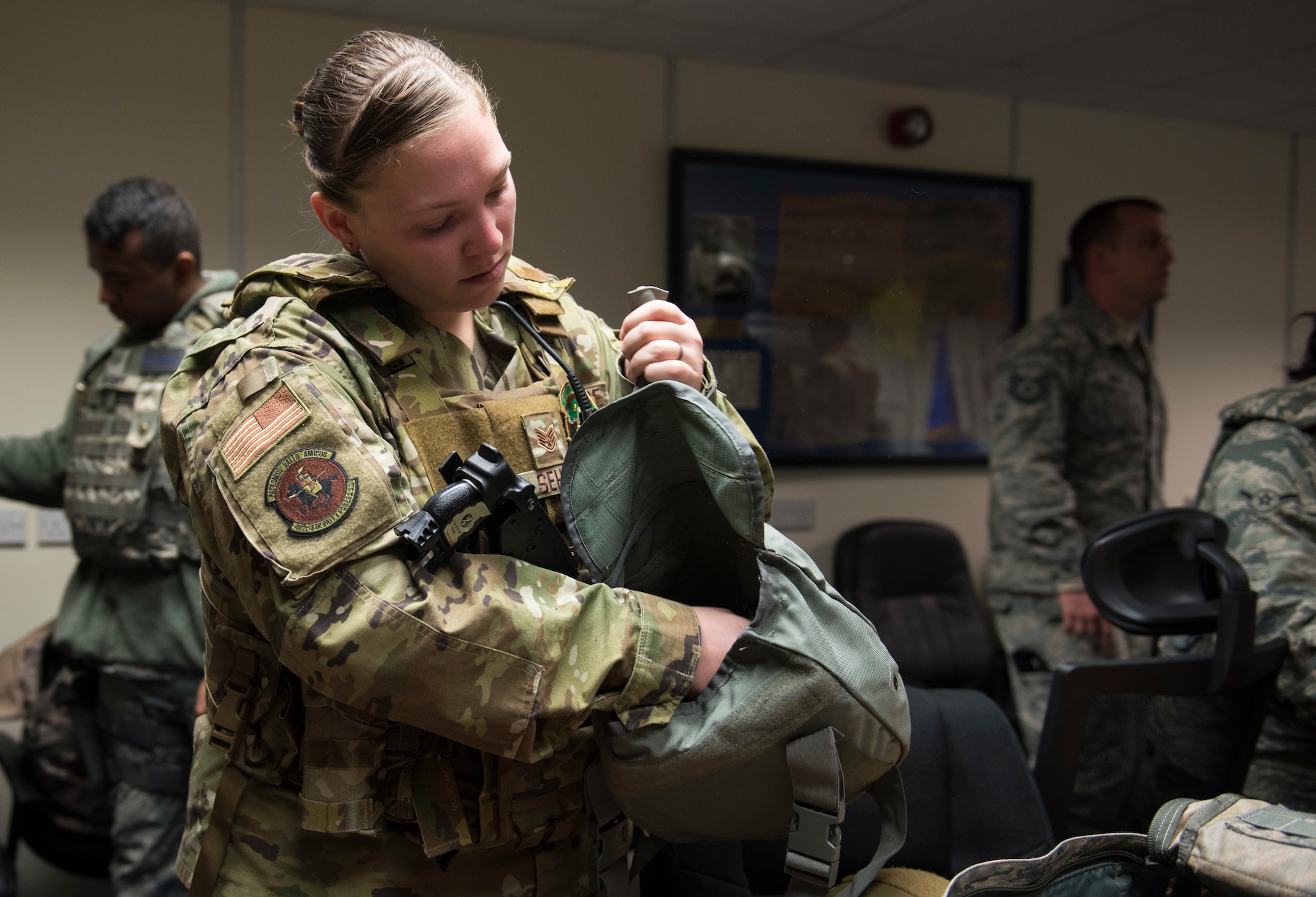 U.S. Air Force Staff Sgt. Nichole Sehle, 422nd Security Forces Squadron NCOIC of standardization and evaluations, locates required equipment during a recall exercise at RAF Croughton, England, November 21, 2019. Quarterly recall exercises are a form of readiness for defenders to always be prepared to respond at a moment’s notice. (U.S. Air Force photo by Airman 1st Class Jennifer Zima)