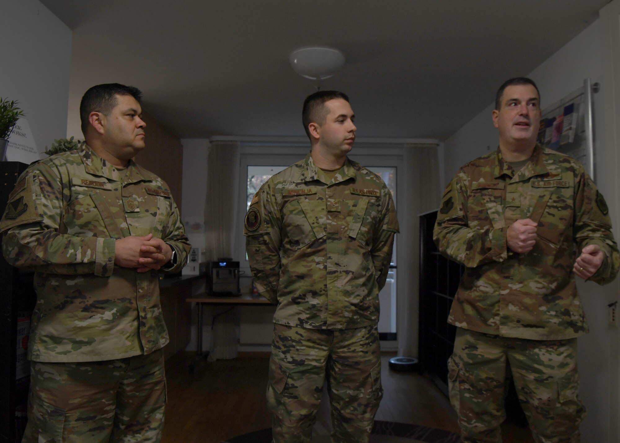 U.S. Air Force Brig. Gen. Mark R. August, 86th Airlift Wing commander, and Chief Master Sgt. Ernesto J. Rendon, 86th AW command chief, praise Senior Airman Eric Mrkonja, Deployment Transition Center lodging manager and vehicle control officer, at Ramstein Air Base, Germany, Nov. 25, 2019. Mrkonja is currently doing the workload performed by two noncommissioned officers, as a senior airman. (U.S. Air Force photo by Staff Sgt. Kirby Turbak)