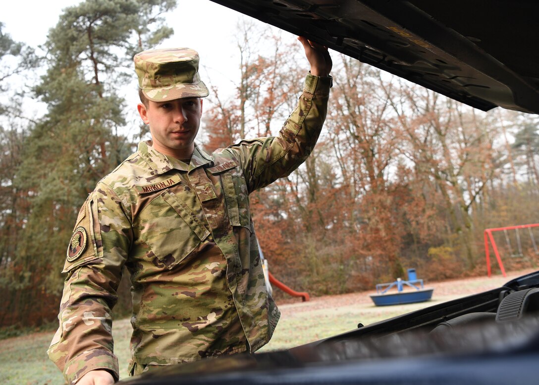 U.S. Air Force Senior Airman Eric Mrkonja, Deployment Transition Center lodging manager and vehicle control officer, inspects a vehicle at Ramstein Air Base, Germany, Nov. 25, 2019. As a member of the DTC, Mrkonja helps provide critical reintegration skills and decompression opportunities for service
members returning home after deployment. (U.S. Air Force photo by Staff Sgt. Kirby Turbak)