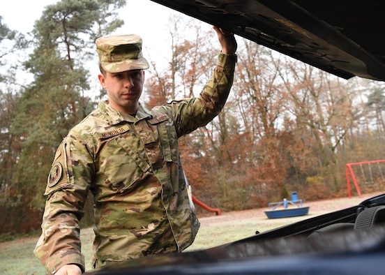 U.S. Air Force Senior Airman Eric Mrkonja, Deployment Transition Center lodging manager and vehicle control officer, inspects a vehicle at Ramstein Air Base, Germany, Nov. 25, 2019. As a member of the DTC, Mrkonja helps provide critical reintegration skills and decompression opportunities for service
members returning home after deployment. (U.S. Air Force photo by Staff Sgt. Kirby Turbak)