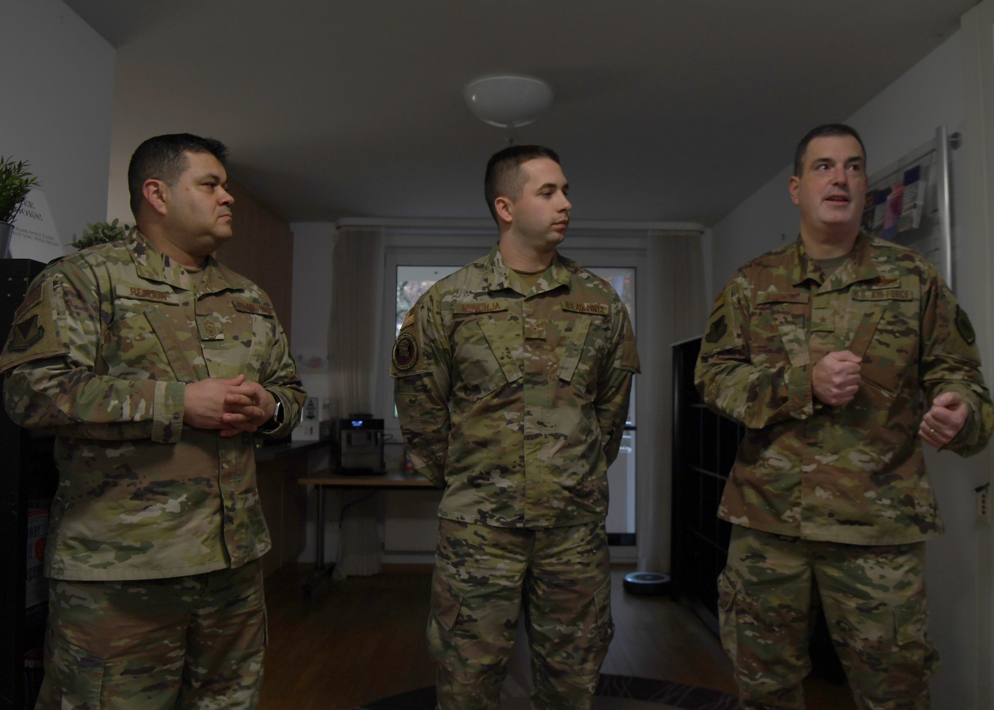 U.S. Air Force Brig. Gen. Mark R. August, 86th Airlift Wing commander, and Chief Master Sgt. Ernesto J. Rendon, 86th AW command chief, praise Senior Airman Eric Mrkonja, Deployment Transition Center lodging manager and vehicle control officer, at Ramstein Air Base, Germany, Nov. 25, 2019. Mrkonja is currently doing the workload performed by two noncommissioned officers, as a senior airman. (U.S. Air Force photo by Staff Sgt. Kirby Turbak)