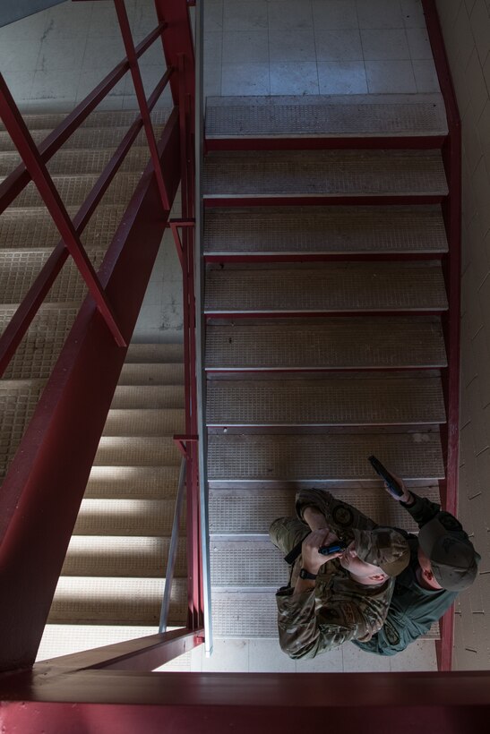 Staff Sgt. James Lunsford (left), with the 137th SOSFS, and Jared Johnson (right), with Ardmore SWAT, tactically clear a stairwell during SWAT training conducted by the Oklahoma County Sheriff's Office at Southern Nazarene University in Bethany, Okla., on Nov. 5, 2019. Johnson, a former Marine Corps infantryman, became a K-9 officer with Ardmore Police Department in 2015 and has worked with the department ever since. Lunsford and Johnson spoke over the course of the training about Johnson’s experiences in that field because Lunsford was in the process of applying to the Oklahoma City Police Department to also become a K-9 handler. (U.S. Air National Guard photo by Staff Sgt. Brigette Waltermire)