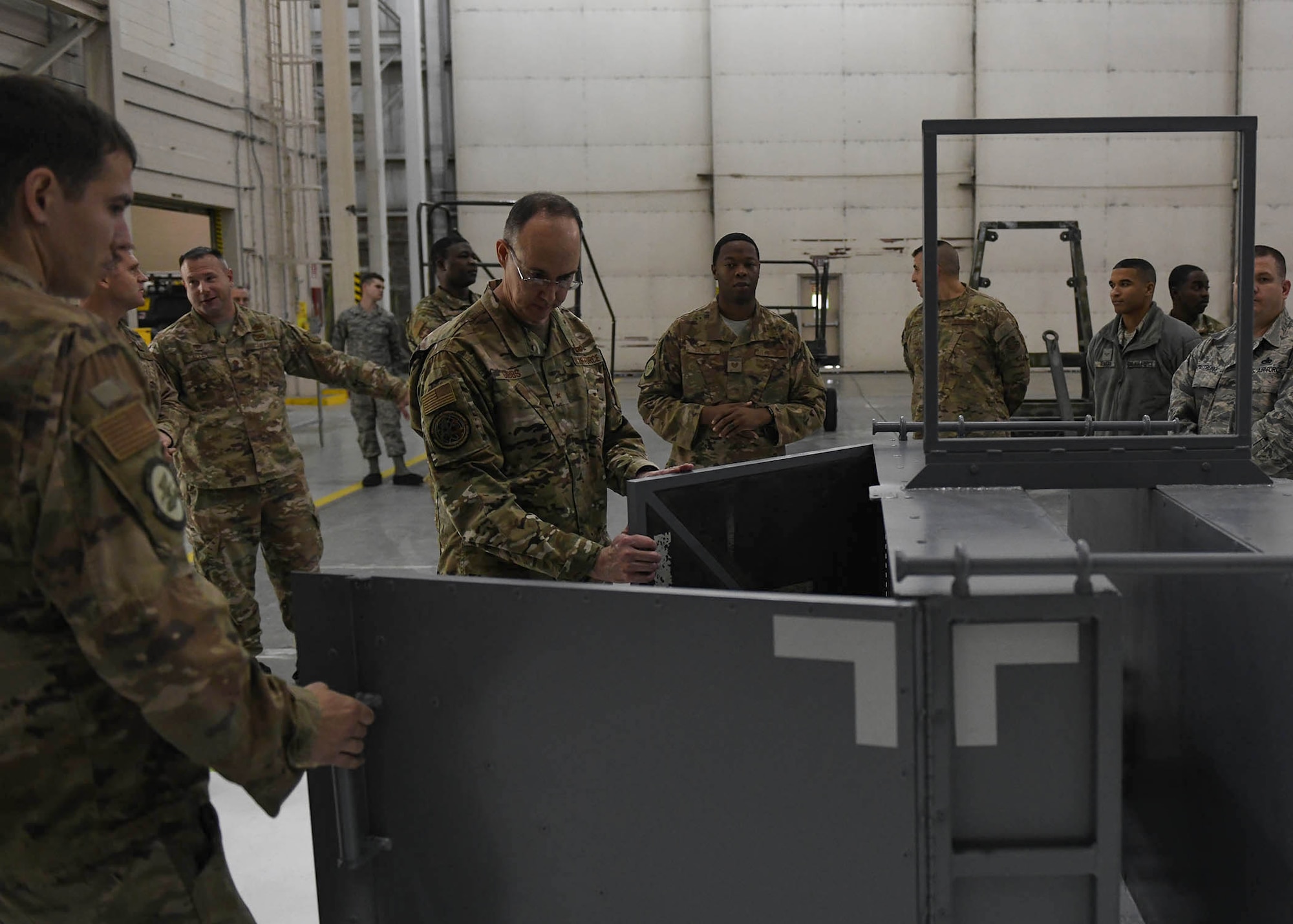 An Airman views the inside of a storage device.