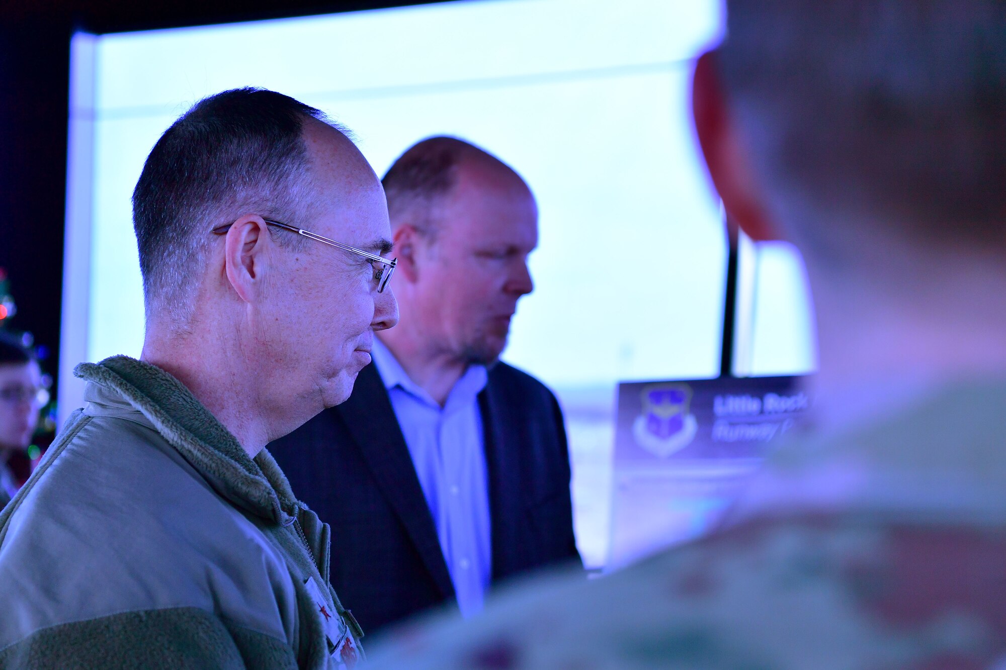 Two men look at a poster board.