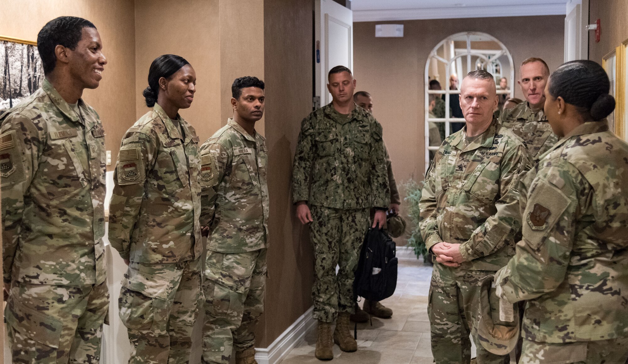 Army Command Sgt. Maj. John Wayne Troxell, senior enlisted advisor to the chairman of the Joint Chiefs of Staff, listens to Master Sgt. Stasia Smith, Air Force Mortuary Affairs Operations Fisher House noncommissioned officer, Dec. 3, 2019, on Dover Air Force Base, Del. Troxell visited the Fisher House to discuss the services provided to families of fallen service members. (U.S. Air Force photo by Roland Balik)