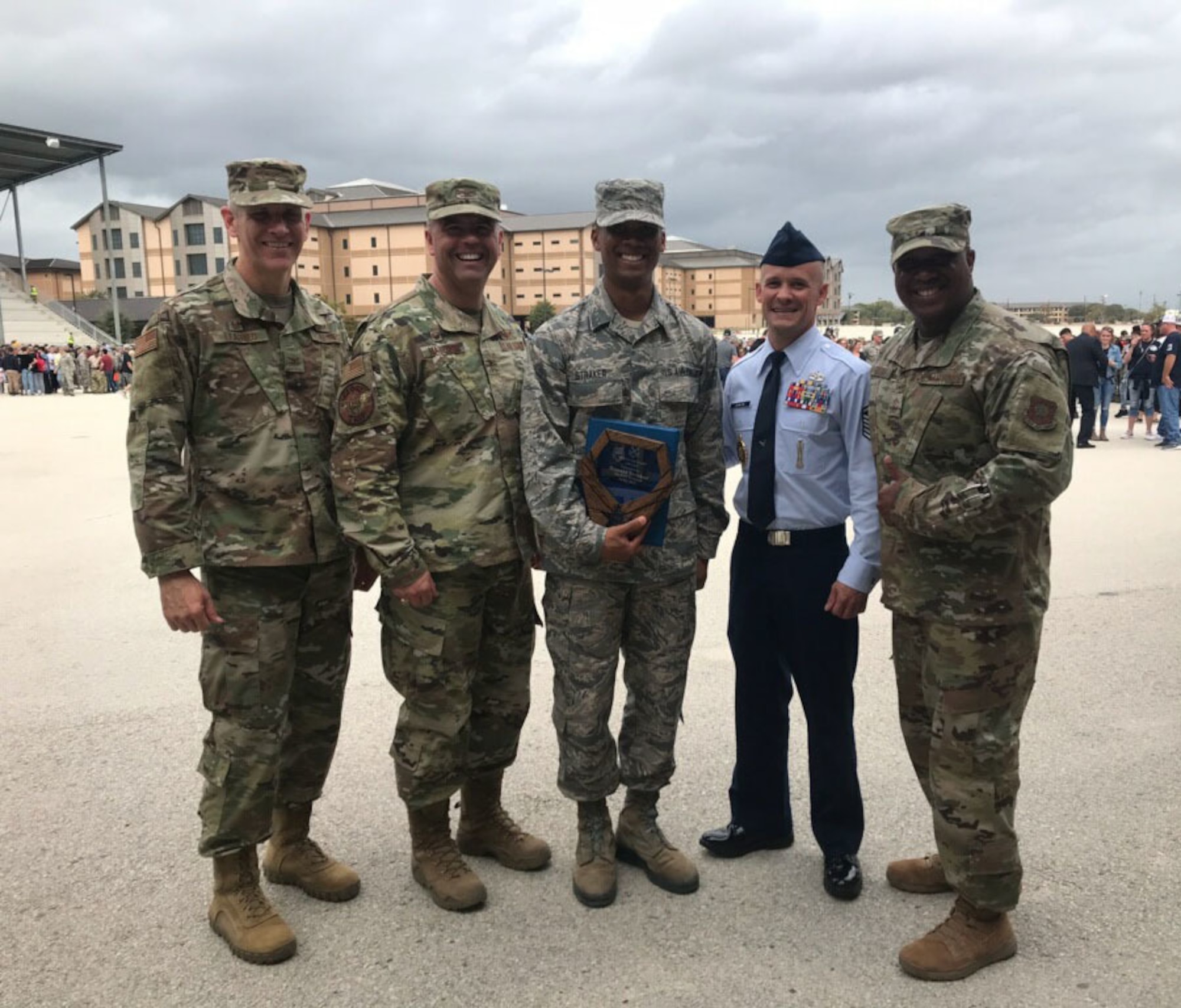 Airman 1st Class Ronald Straker, center, an Airman with the 118th Wing, Tennessee Air National Guard, poses with his recruiter and leadership at basic military training graduation Oct. 25, 2019 at Lackland Air Force Base, San Antonio, Texas.