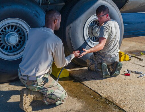 Tech. Sgt. Caleb Black, 913th Maintenance Squadron crew chief, hands pliers to a fellow maintainer while they inspect and repair the wheels of a C-130J Hercules on Aug. 15, 2019, at Little Rock Air Force Base, Ark. Black has been with the 913th Airlift Group for more than six years as a traditional reservist. The majority of our Reserve members have to meet the same requirements of Active Duty personnel. This means they have to balance a full-time civilian job or college studies while maintaining their military readiness. (U.S. Reserve photo by Maj. Ashley Walker)