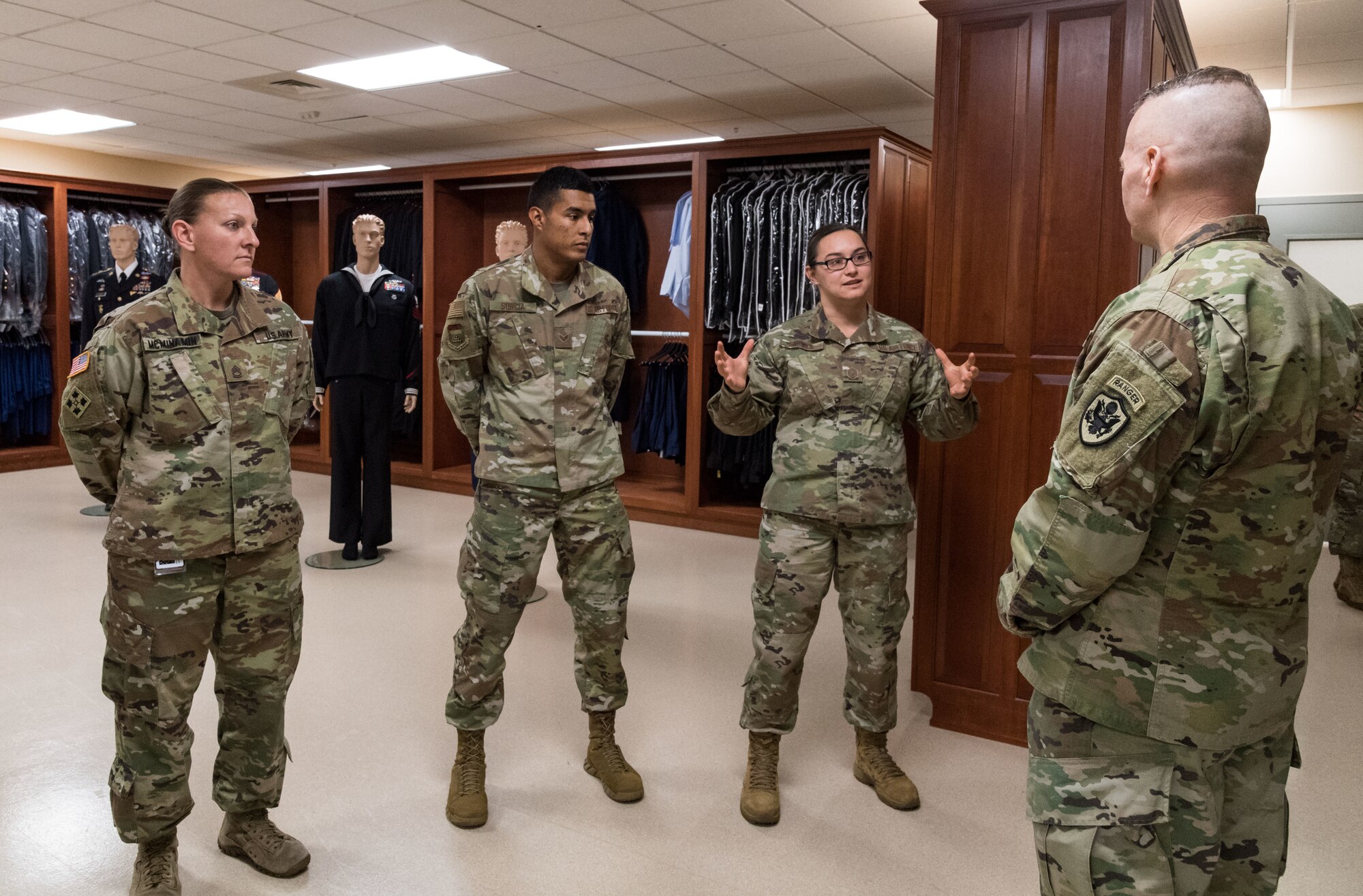 Master Sgt. Naomi Bouska, Air Force Mortuary Affairs Operations  noncommissioned officer in charge of uniforms, briefs Army Command Sgt. Maj. John Wayne Troxell, senior enlisted advisor to the chairman of the Joint Chiefs of Staff, Dec. 3, 2019, during an orientation of the mortuary facility. Troxell thanked Bouska, Sgt. 1st Class Nicole McMinamin and Senior Airman Isai Sorcia for their service in providing dignity, honor and respect to fallen service members. (U.S. Air Force photo by Roland Balik)