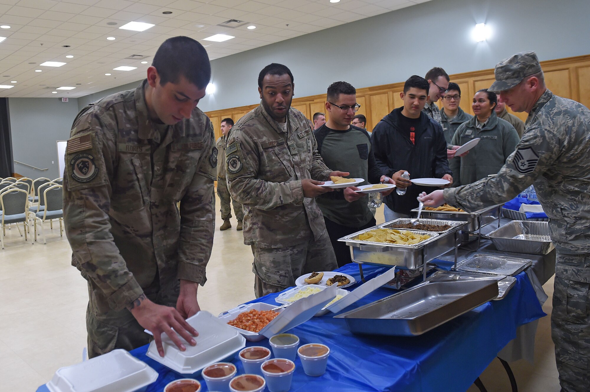 Airmen stand in line for food