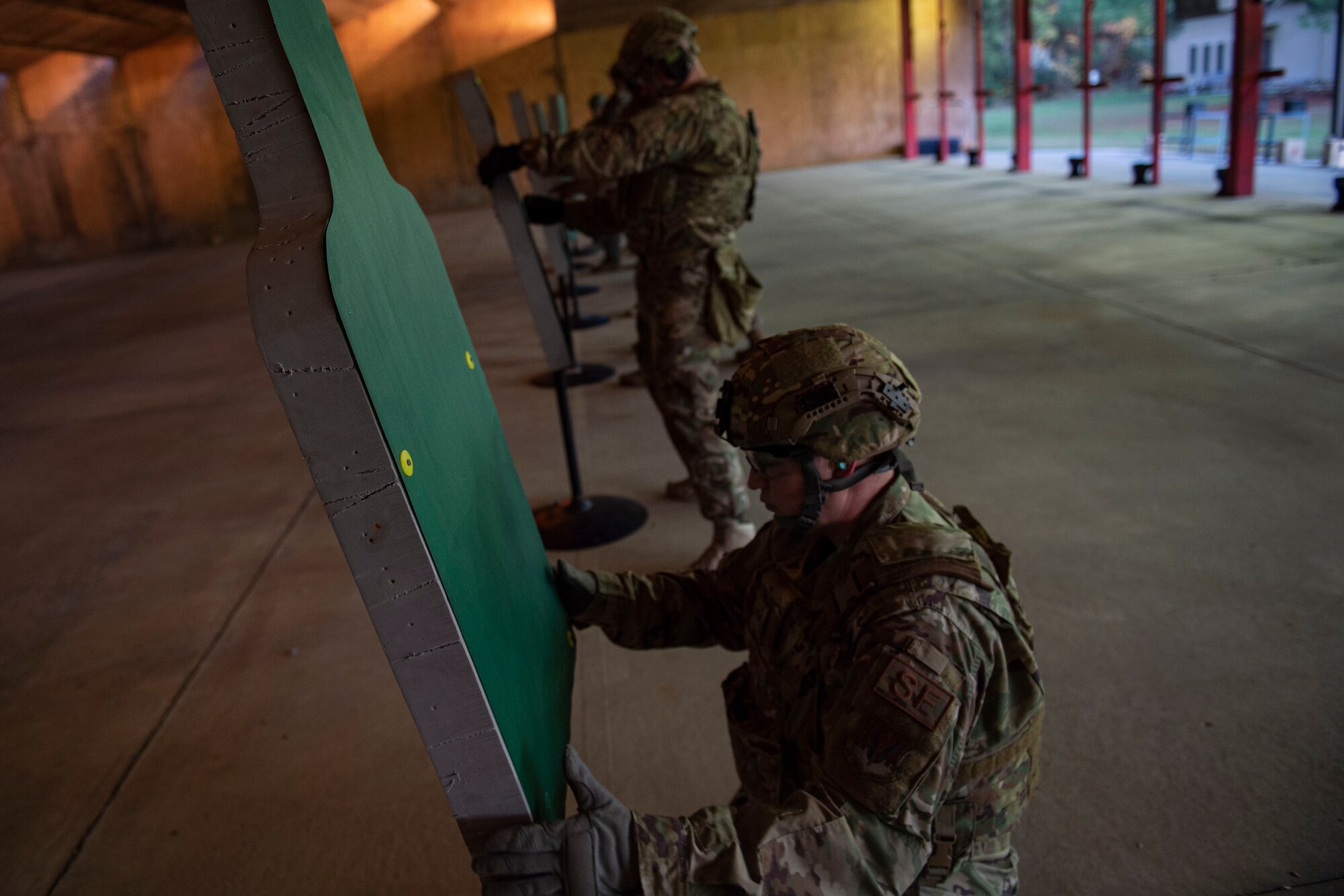 Photo of Airmen placing targets during an M4 and M9 Air Force Qualification Course