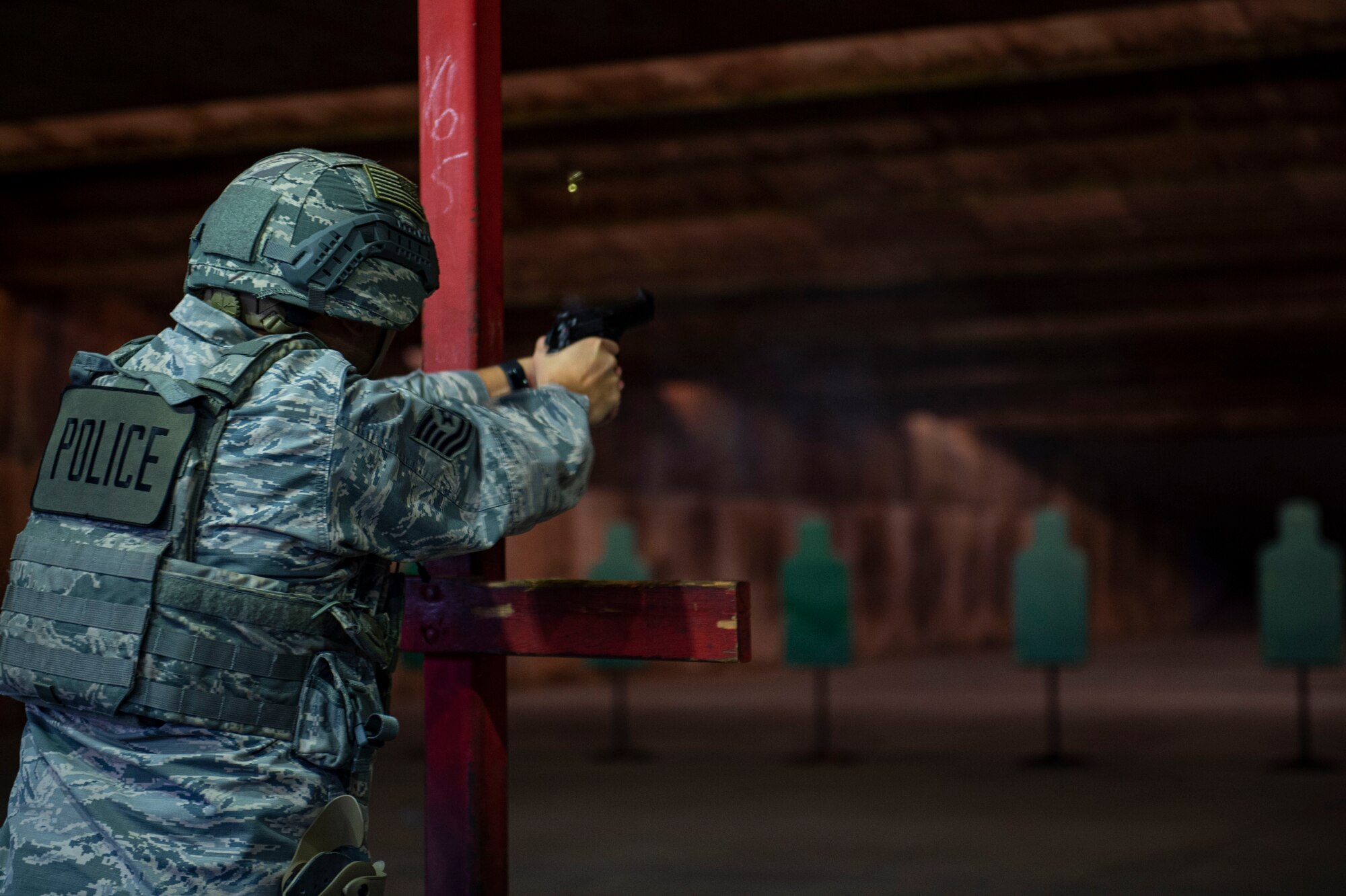 Photo of an Airman firing an M9 during an M4 and M9 Air Force Qualification Course