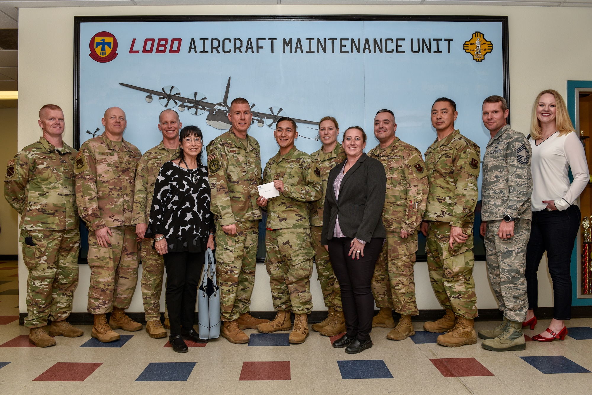 Group photo with award recipient in center.