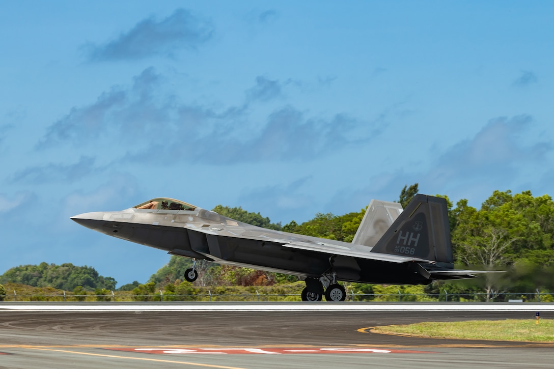 A jet lands on a runway.