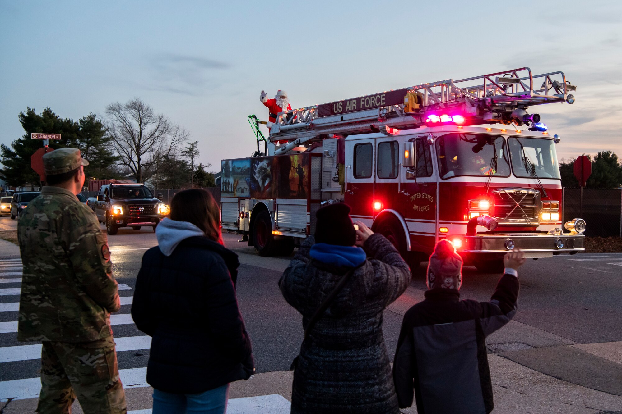 Santa waves from a 436th Civil Engineer Squadron fire truck to all the family and friends attending the 2019 Dover Air Force Base Holiday Parade Dec. 3, 2019, at Dover Air Force Base, Del. A variety of military and first responder vehicles were decorated for the event. (U.S. Air Force photo by Senior Airman Christopher Quail)