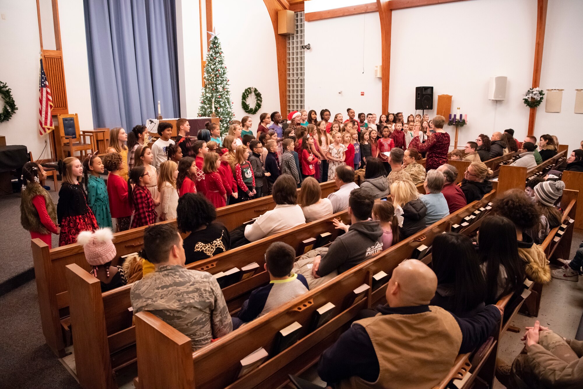 Students from Major George S. Welch Elementary School perform Christmas carols at the holiday tree lighting ceremony Dec. 3, 2019, at Dover Air Force Base, Del. The annual event was hosted by the chapel staff. (U.S. Air Force photo by Senior Airman Christopher Quail)