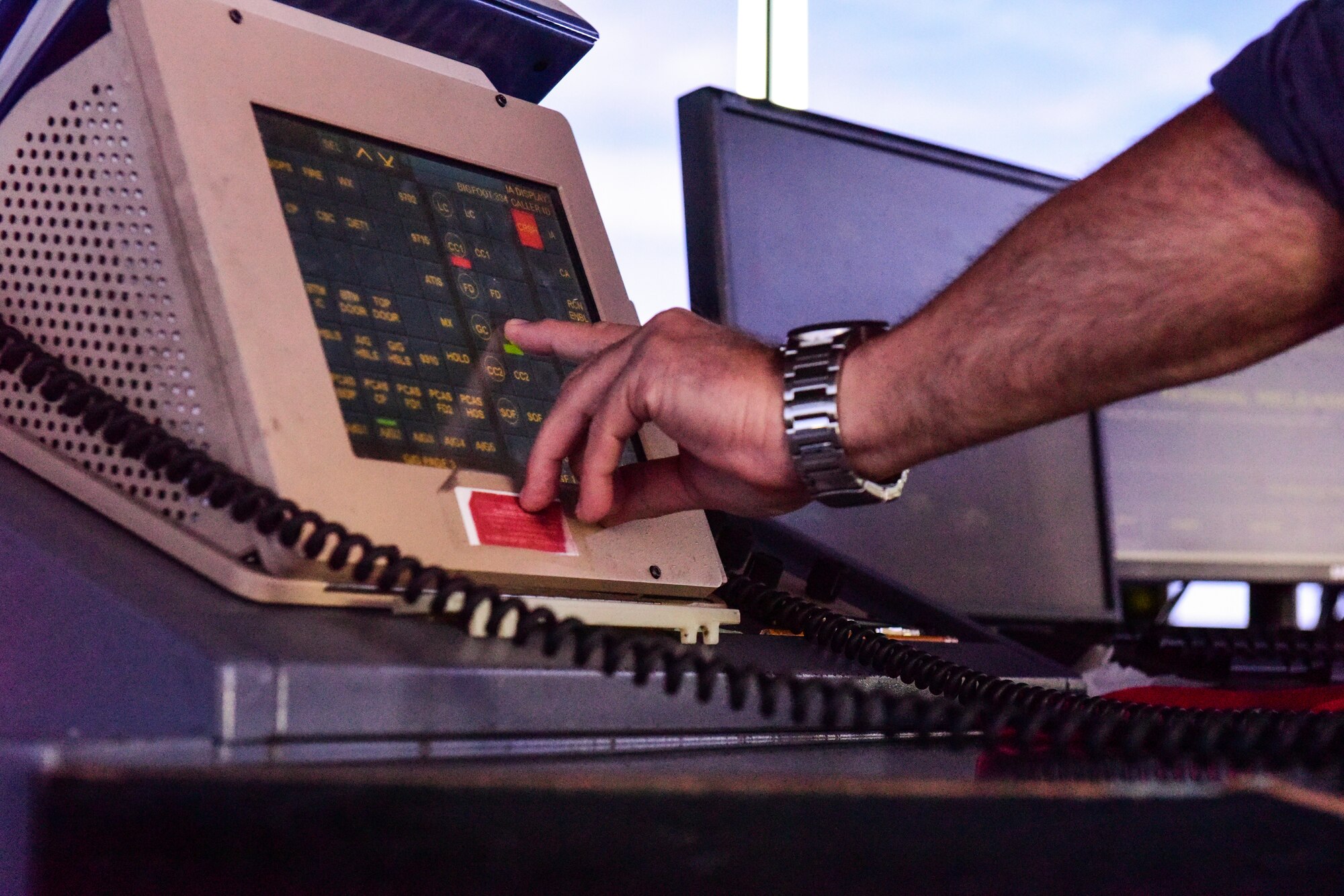 A photo of the watch supervisor touching a computer