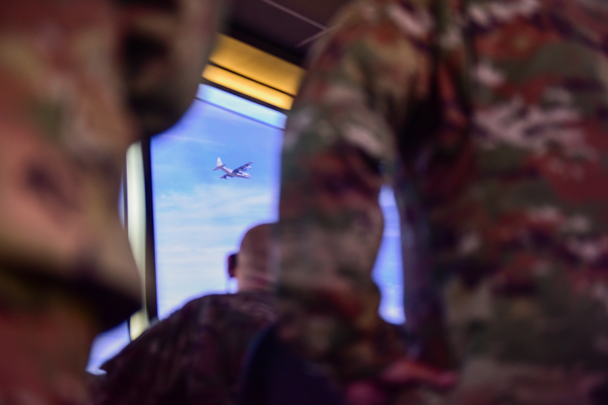 A photo of airmen watching a plane take off