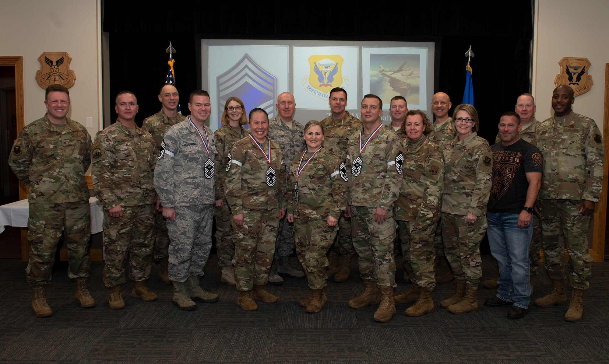 Four chief master sergeants select and current chief master sergeants from across Whiteman Air Force Base, Missouri, pose for a photo with Col. Jeffrey Shreiner and Chief Master Sgt. Katie McCool, the 509th Bomb Wing commander and command chief, on Dec. 4, 2019. By federal law, Airmen holding the rank of chief master sergeant make up only roughly one percent of Air Force manning. (U.S. Air Force photo by Staff Sgt. Kayla White)