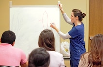 Army Capt. Vanessa Seig, emergency physician, Carl R. Darnall Army Medical Center instructs a suture clinic for premedical students during the American Medical Student Association Premed Fest at Texas A&M University Nov. 24.