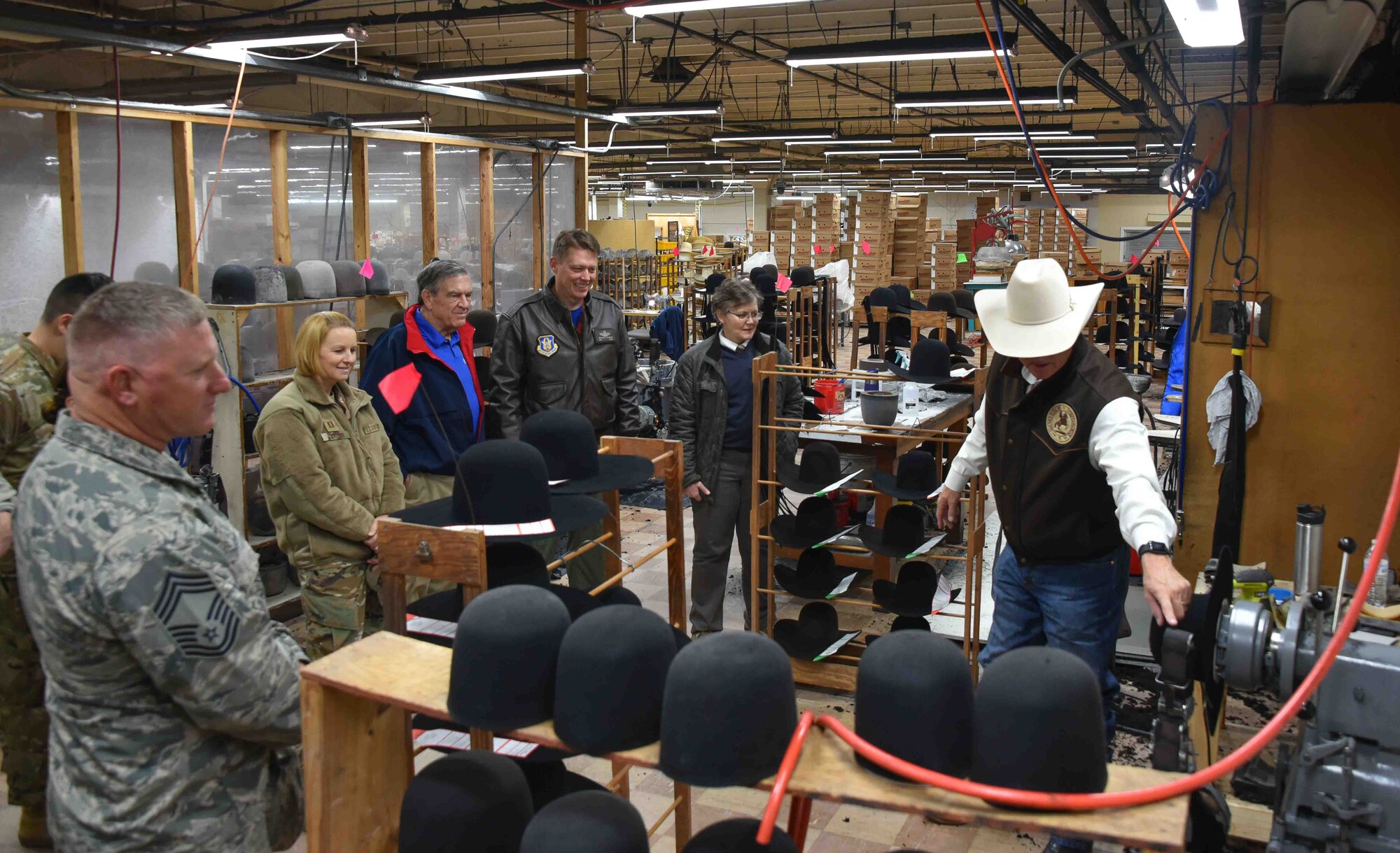 301st Fighter Wing Aircraft Maintenance Squadron Honorary Commander Mr. Keith Mundee (right), who is also the president of American Hat Co., leads several members of the wing's leadership on a factory tour of American Hat Company in Bowie, Texas on November 15, 2019. The 301st Fighter Wing Honorary Commanders Program has invited civic leaders to many behind-the-scenes military tours but this was the first time we were hosted by one of our honorary commanders. (U.S. Air Force photo by Mr. Jeremy Roman)
