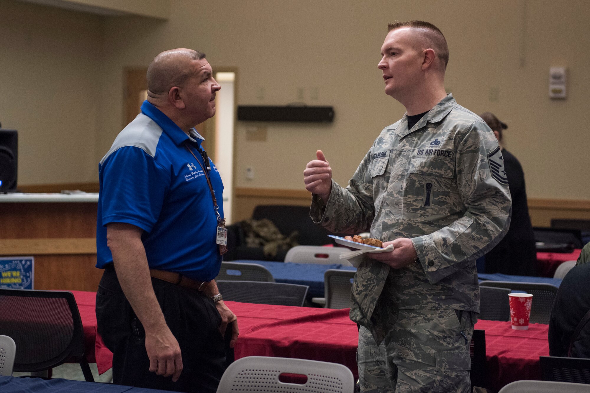Jonathan Hernandez, Air Force Alaskan region recovery care coordinator, talks to U.S. Air Force MSgt. Jason Biddlecome, 3rd Operations Support Squadron first sergeant, during the annual Warrior Care breakfast, at Joint Base Elmendorf-Richardson, Alaska, Nov. 22, 2019. The event was held in honor of Military Appreciation and Warrior Care month, and featured guest speakers Alvin Shell and fellow Air Force Wounded Warriors. (U.S. Air Force photo by Senior Airman Caitlin Russell)
