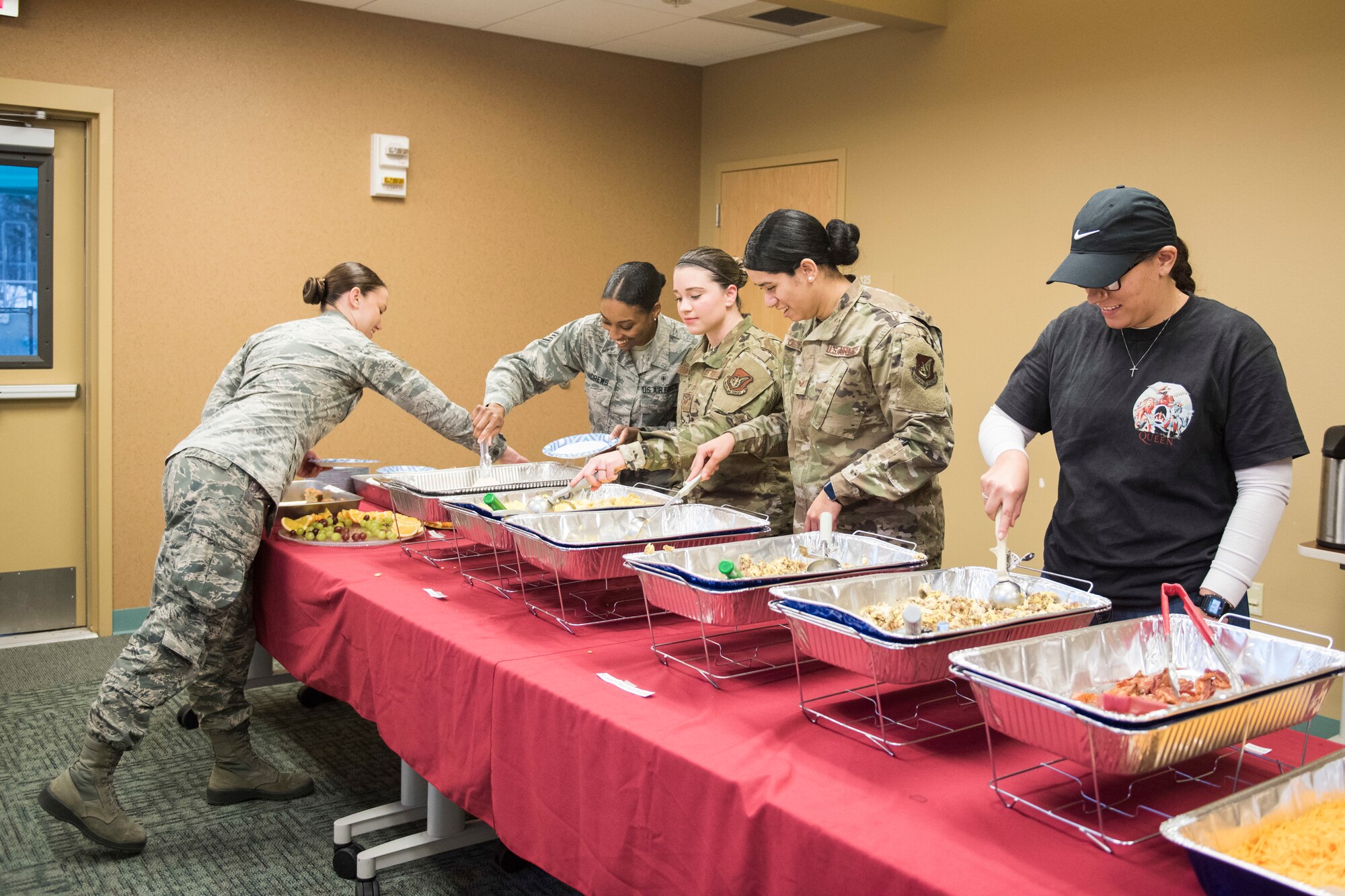 Joint Base Elmendorf-Richardson Airmen grab breakfast during the annual Warrior Care breakfast, at JBER, Alaska, Nov. 22, 2019. The event was held in honor of Military Appreciation and Warrior Care month, and featured guest speakers Alvin Shell and fellow Air Force Wounded Warriors. (U.S. Air Force photo by Senior Airman Caitlin Russell)