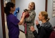 Hospital personnel hold a therapy dog.