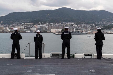 SASEBO, Japan (Dec. 6, 2019) Sailors man the rails as the amphibious assault ship USS America (LHA 6) arrives at Sasebo, Japan to join the forward-deployed naval forces. America is assigned to Amphibious Squadron Eleven and will serve as the flagship for Expeditionary Strike Group 7 while conducting routine operations in the Western Pacific.