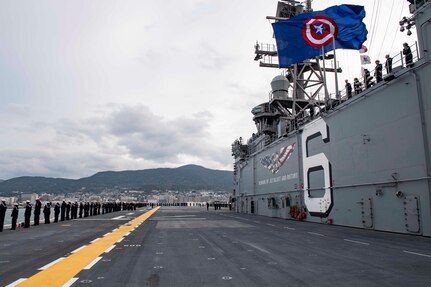 SASEBO, Japan (Dec. 6, 2019) Sailors man the rails as the amphibious assault ship USS America (LHA 6) arrives at Sasebo, Japan to join the forward-deployed naval forces. America is assigned to Amphibious Squadron Eleven and will serve as the flagship for Expeditionary Strike Group 7 while conducting routine operations in the Western Pacific.