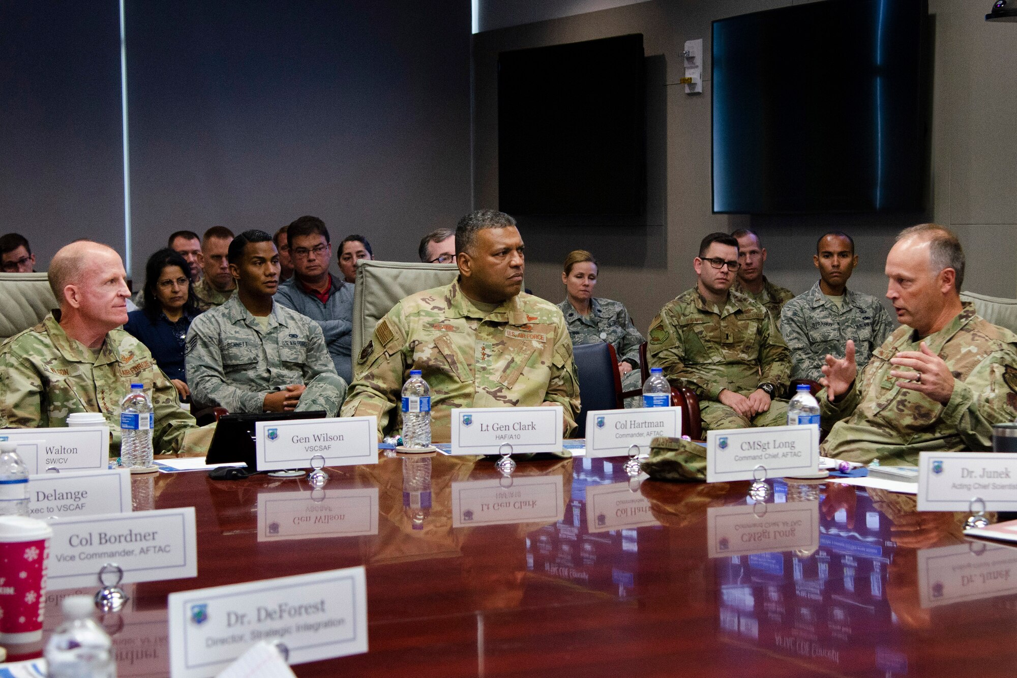 Col. Chad J. Hartman (right), commander of the Air Force Technical Applications Center, briefs Air Force Vice Chief of Staff Gen. Stephen W. "Seve" Wilson (left) and Air Force Deputy Chief of Staff for Strategic Deterrence and Nuclear Integration Lt. Gen. Richard Clark (center) on algorithmic warfare operations being conducted at the Department of Defense's sole nuclear treaty monitoring center.  Wilson and Clark visited AFTAC, headquartered at Patrick AFB, Fla., Dec. 4, 2019 for a current mission update.  (U.S. Air Force photo by Susan A. Romano)