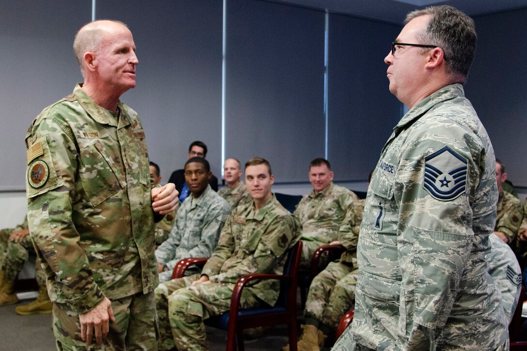 Gen. Stephen W. "Seve" Wilson (left), Air Force Vice Chief of Staff, presents his coin to Master Sgt. Ryan Doss, a mission director for the Air Force Technical Applications Center at Patrick AFB, Fla., after Doss was recognized as an outstanding performer by his chain of command.  Wilson visited the AFTAC Dec. 4, 2019 with Air Force Deputy Chief of Staff for Strategic Deterrence and Nuclear Integration Lt. Gen. Richard Clark for an in-depth look into how the nuclear treaty monitoring center accomplishes its global mission.  (U.S. Air Force photo by Susan A. Romano)