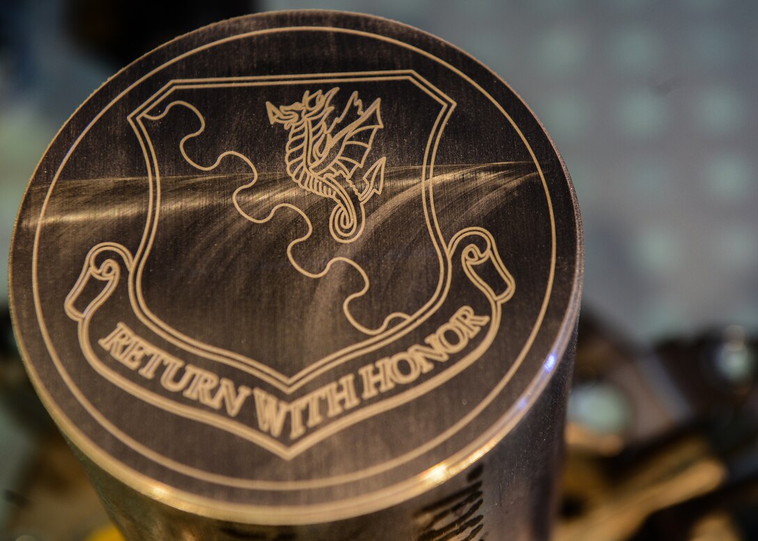 A piece of metal with the 31st Fighter Wing shield engraved on top sits at Aviano Air Base, Italy, Dec. 4, 2019. The mission of the 31st FW is to deter through safe, secure, effective operations and to win the current fight and be ready to win the next fight. (U.S. Air Force photo by Airman Thomas S. Keisler IV)