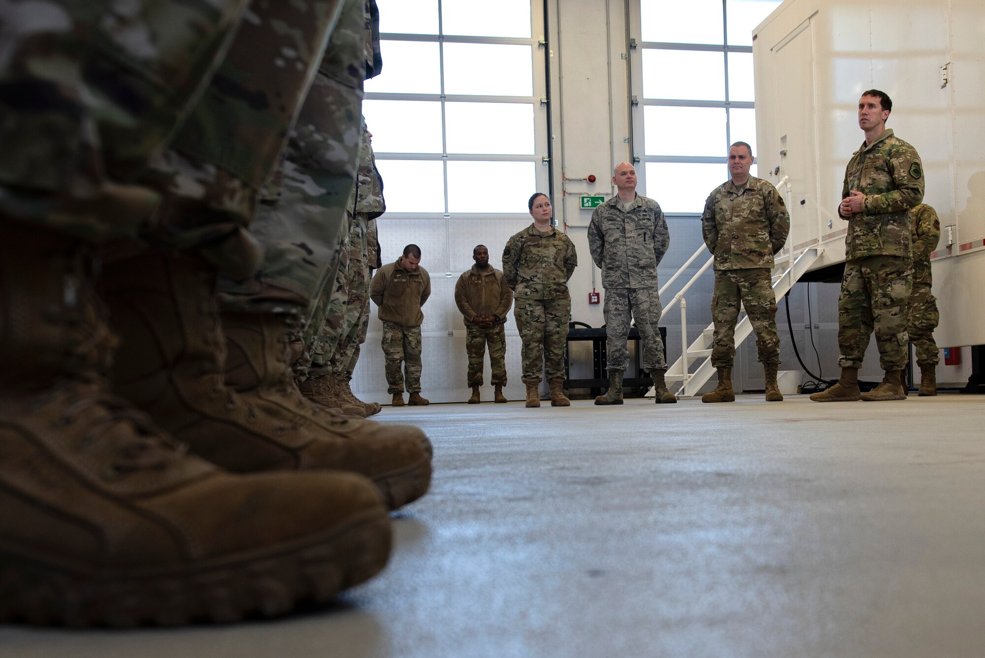 U.S. Air Force Col. David Epperson, 52nd Fighter Wing commander, right, speaks with Airmen from the 702nd Munitions Support Squadron at Buechel Air Base, Germany, Dec. 5, 2019. Epperson toured facilities around the geographically separated unit to gain a better understanding of the 702nd MUNSS's capabilities. (U.S. Air Force photo by Airman 1st Class Valerie Seelye)