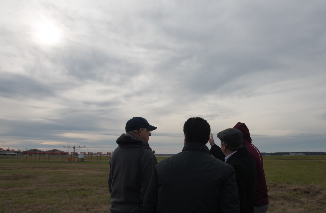 Team members of the NASA Langley Research Center look down the flight line at Joint Base Langley-Eustis, Virginia, Nov. 26, 2019. The NASA LaRC team members tested new technology in a test laser that will be used in future missions. (U.S. Air Force photo by Airman 1st Class Sarah Dowe)