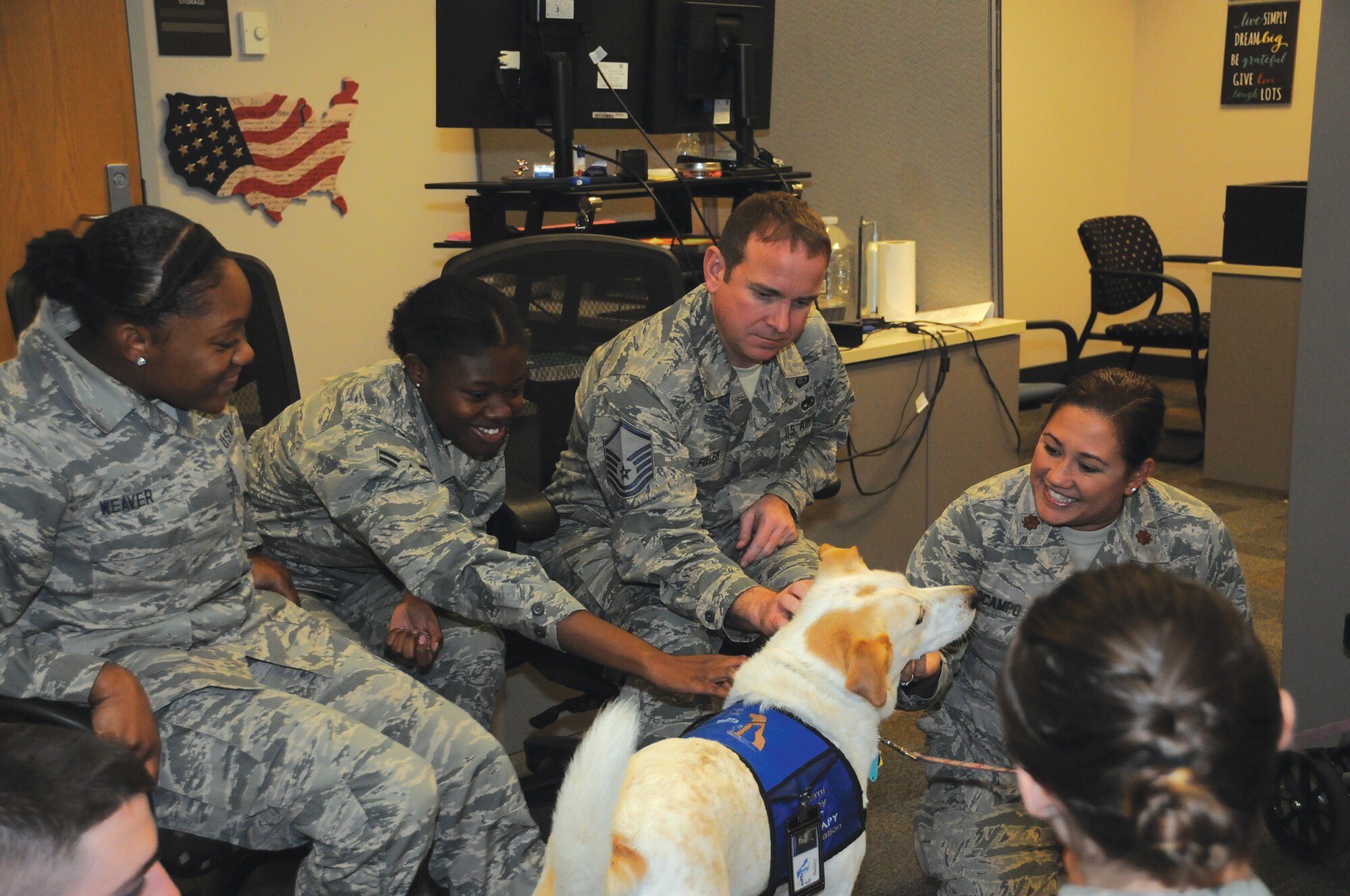 Airmen from the 445th Force Support Squadron interact with Bailey, a therapy dog, during the unit's Tactical Pause Nov. 3, 2019.