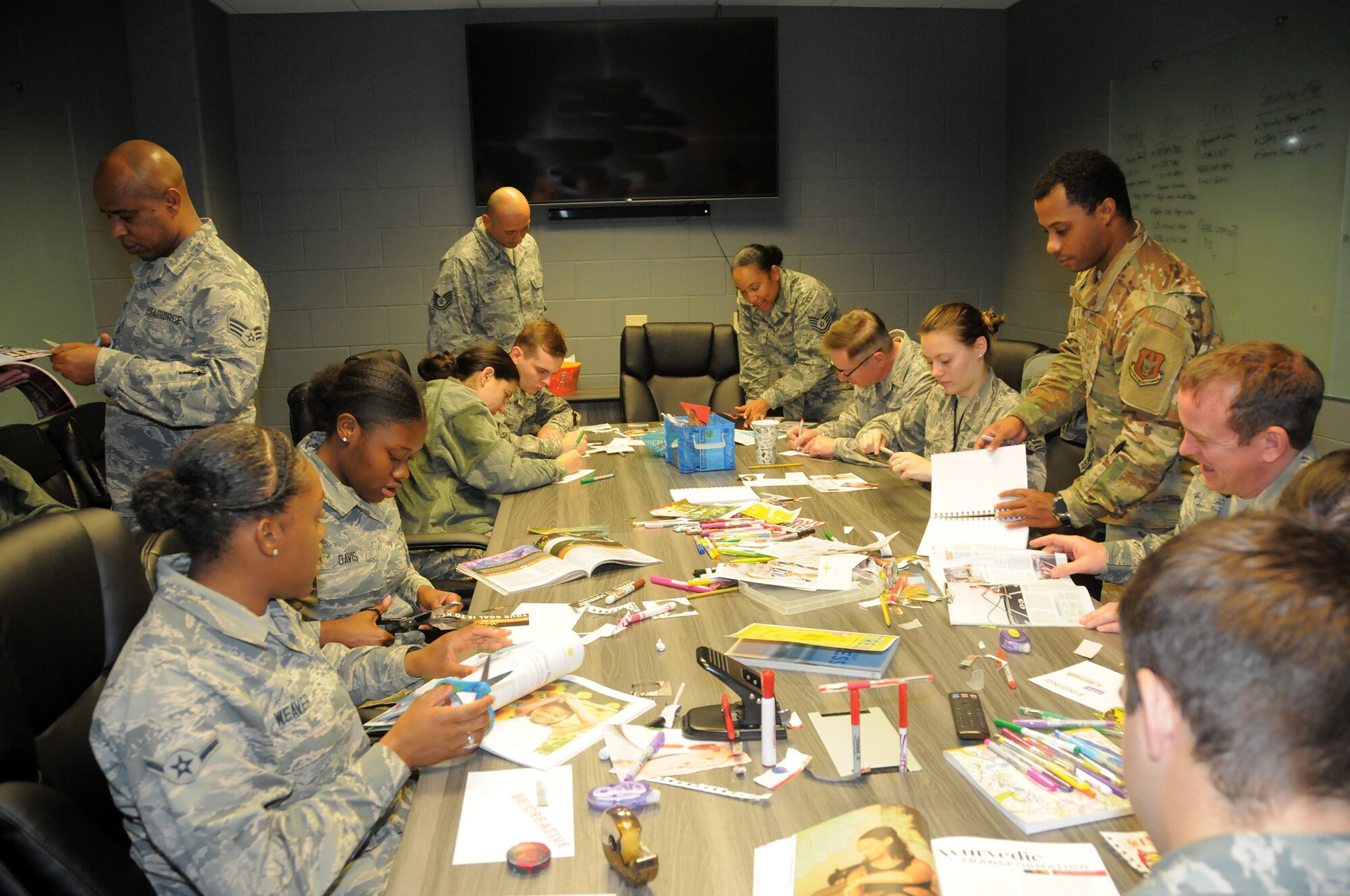 Members of the 445th Force Support Squadron construct vision boards of goals they would like to accomplish within the next year as part of their tactical pause day Nov. 3, 2019.