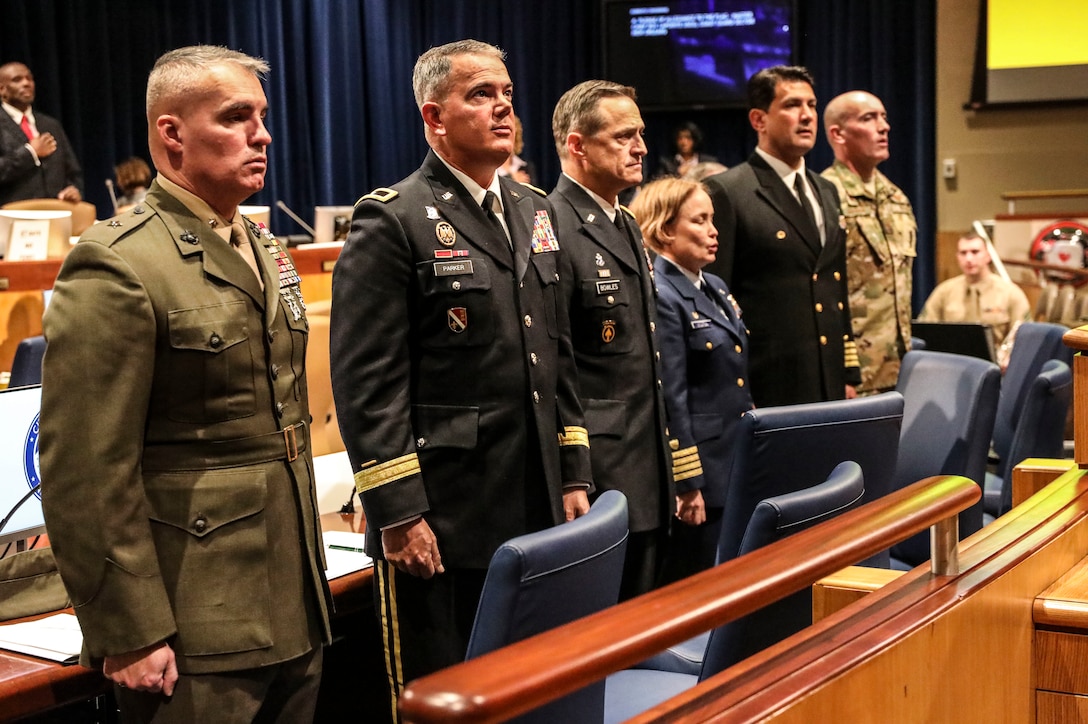 Brig. Gen. William Souza, left, deputy commander of Marine Forces Reserve and Marine Forces North, and key leaders from each branch of military service stand at attention during the pledge of allegiance while attending the 2019 Military Appreciation Day ceremony at New Orleans City Hall, Dec. 5, 2019. Military Appreciation Day with the New Orleans City Council is celebrated annually to honor service members from each military branch for their hard work, and to strengthen the relationship between military service, state and federal agencies in Louisiana. (U.S. Marine Corps photo by Sgt. Melissa Martens)