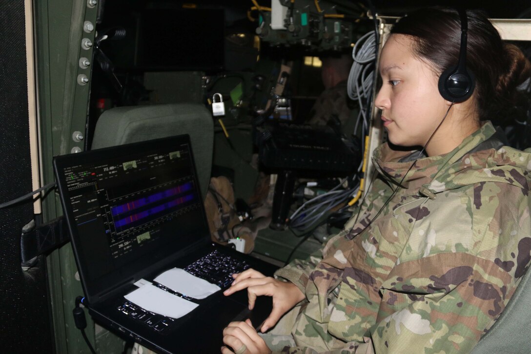 Woman works on laptop.