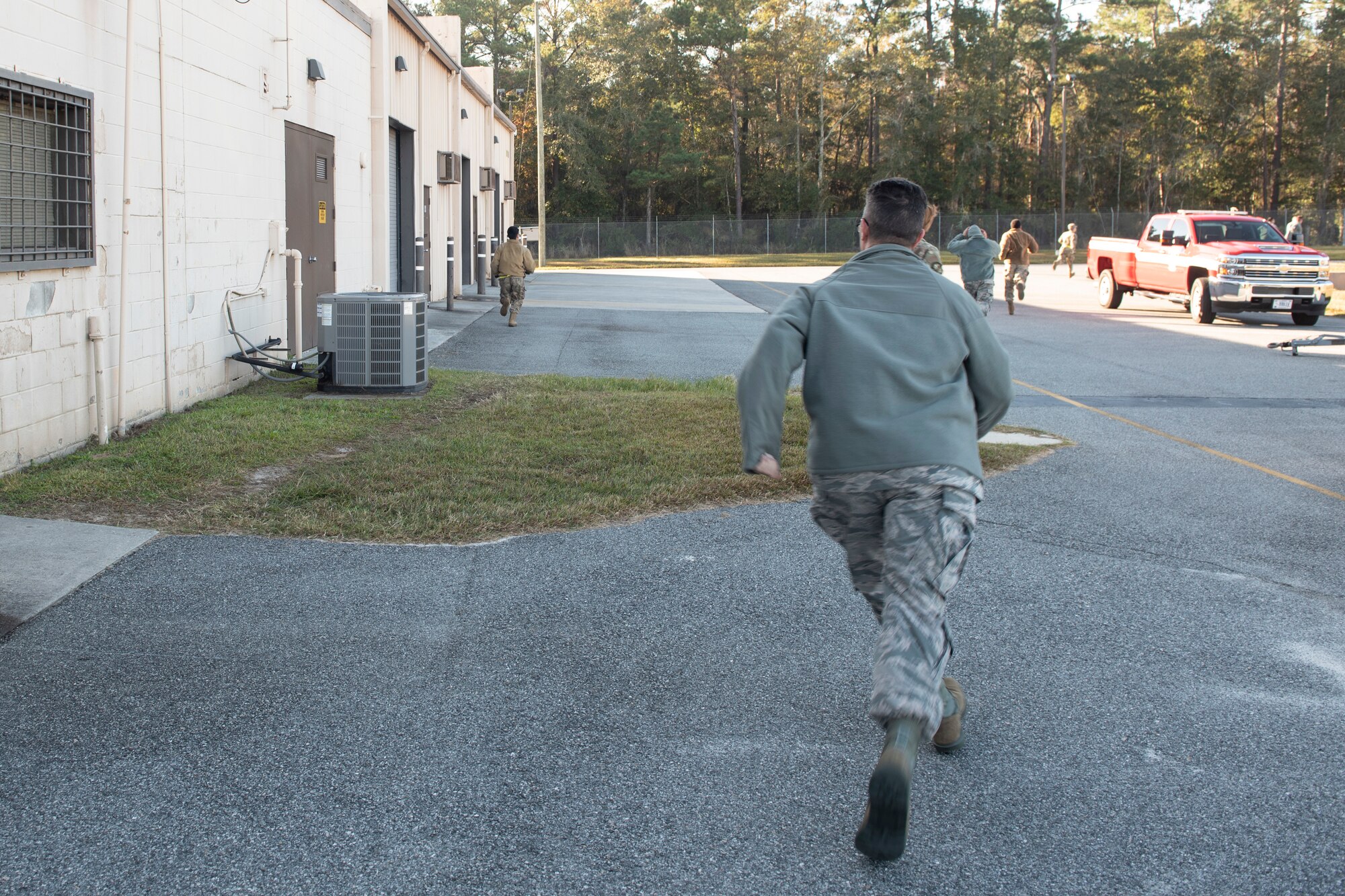 A photo of munitions Airmen evacuating a building during an evacuation drill.