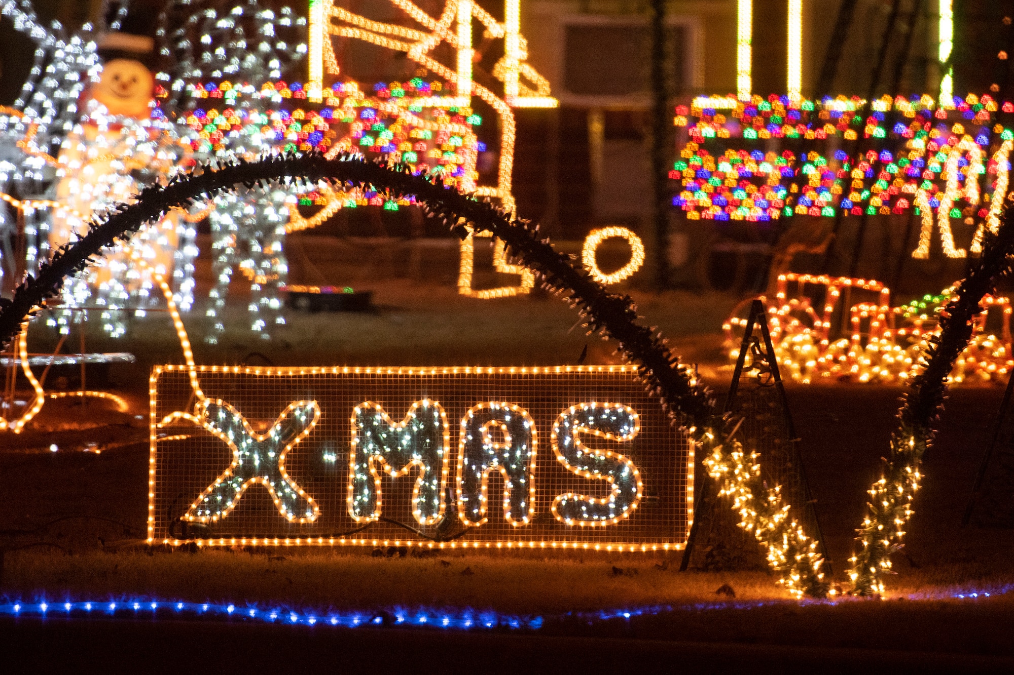 Military family displays holiday lights.