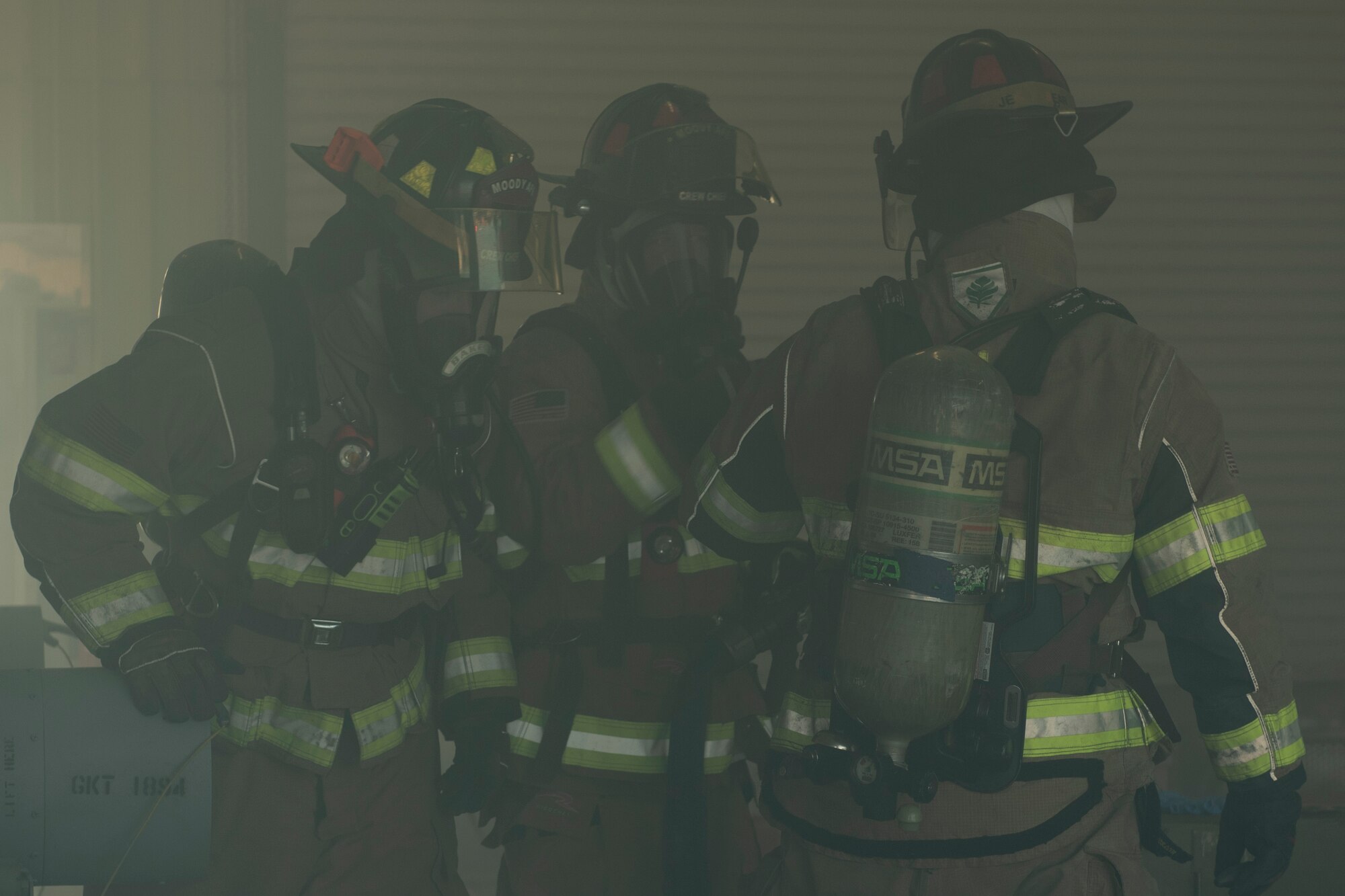 A photo of Airmen with the 23d Civil Engineer Squadron Fire Emergency Flight communicating during an evacuation drill.